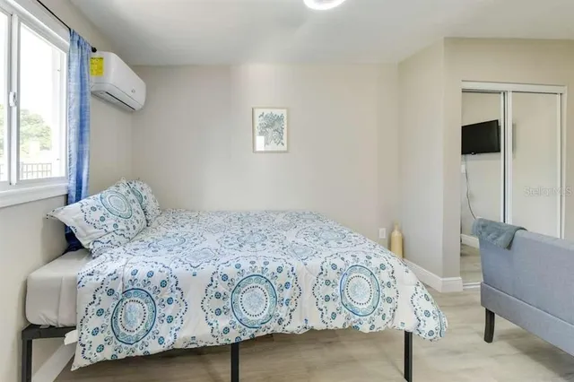 a living room with furniture wooden floor and a flat screen tv