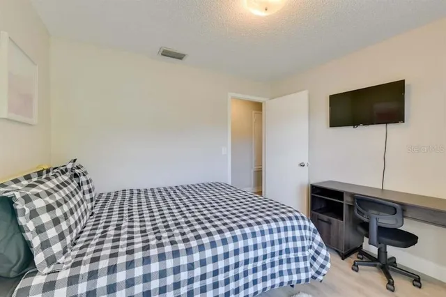 a bedroom with a bed and a desk