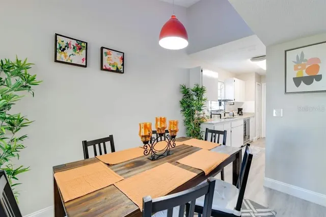 a living room with furniture potted plant and a flat screen tv