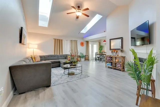 a living room with furniture a fireplace and a flat screen tv