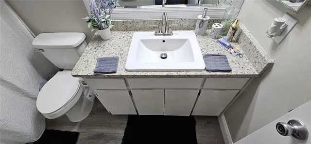 a view of bathroom with a sink and mirror