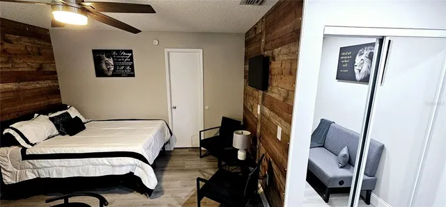 a bedroom with a bed a mirror and a window