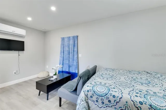 a bedroom with a bed and a flat screen tv