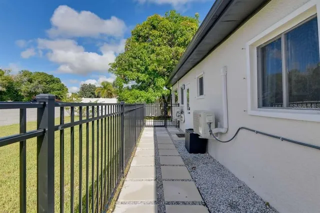 a view of a house with backyard and sitting area