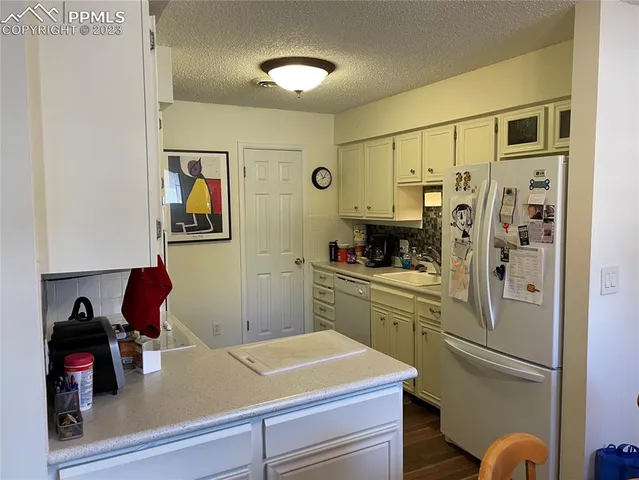 a kitchen with stainless steel appliances a refrigerator and a stove top oven