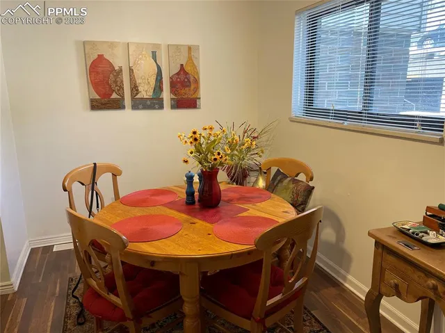 a view of a dining room with furniture and chandelier