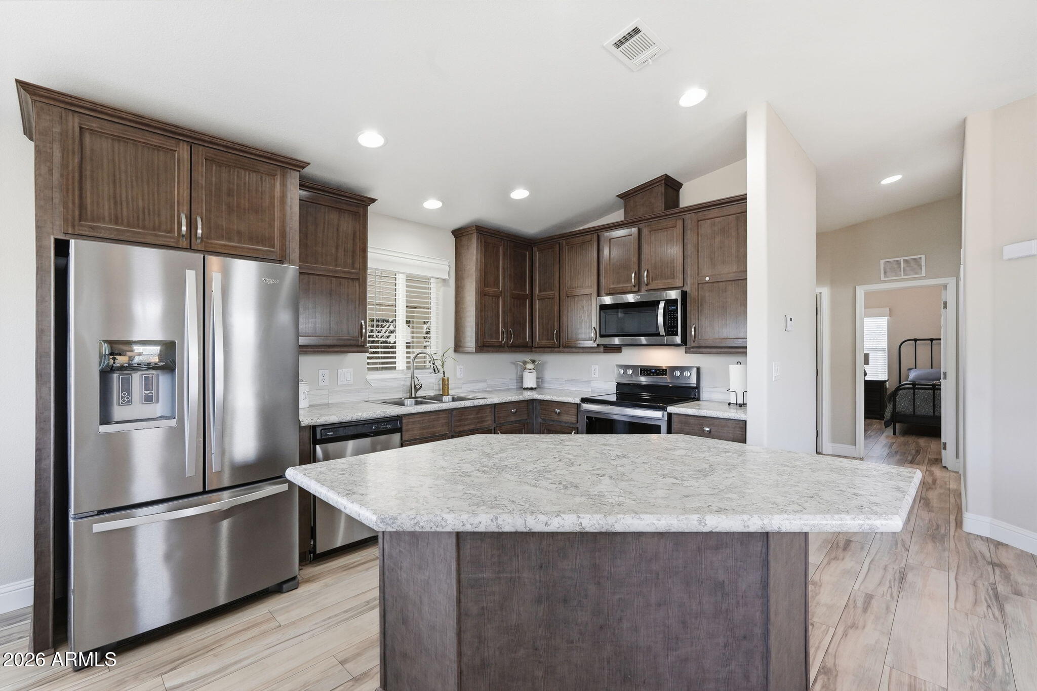 8865 East Baseline Road, Unit 1417 Mesa, AZ 85209 - Photo 4 of 47 a kitchen with granite countertop a refrigerator a sink a stove a microwave and wooden floor