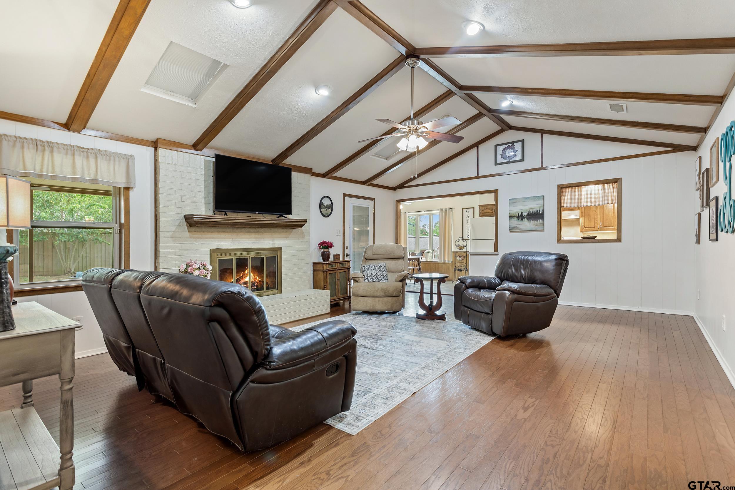 516 Ruthlynn Drive Longview, TX 75605 - Photo 5 of 34 a living room with furniture a fireplace and a flat screen tv