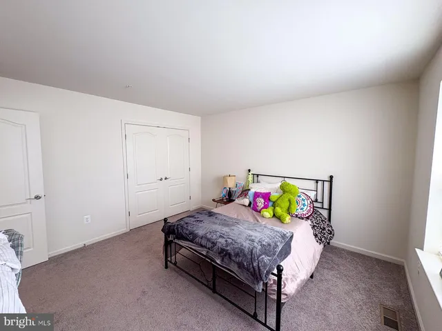 a view of a hallway with a couch and a window