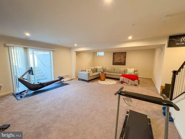 a view of staircase with railing and white walls