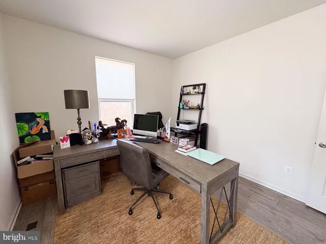 a spacious bedroom with a bed and a flat screen tv