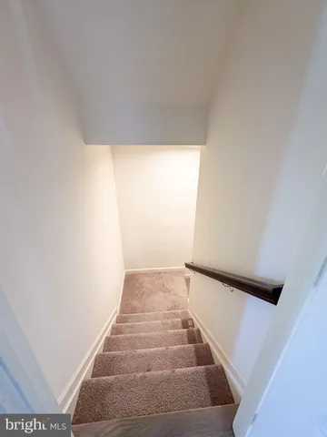 a spacious bathroom with a double vanity sink a large mirror and a bathtub
