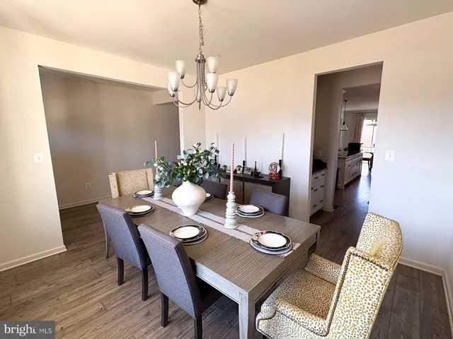 a view of a dining room with furniture wooden floor and chandelier