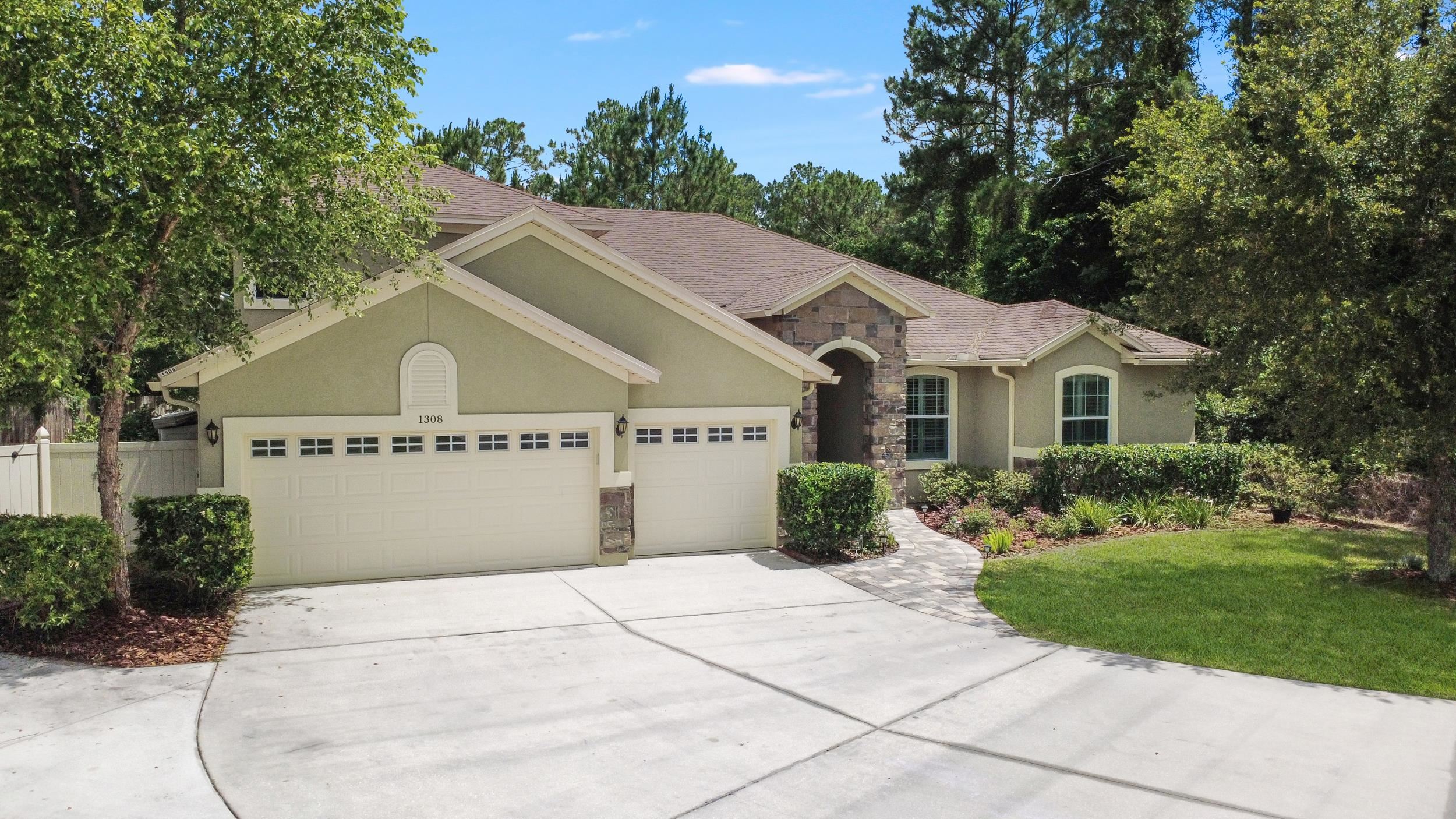 1308 Acorn Ridge Court St. Augustine, FL 32092 - Photo 2 of 47 a view of house and garden with large trees