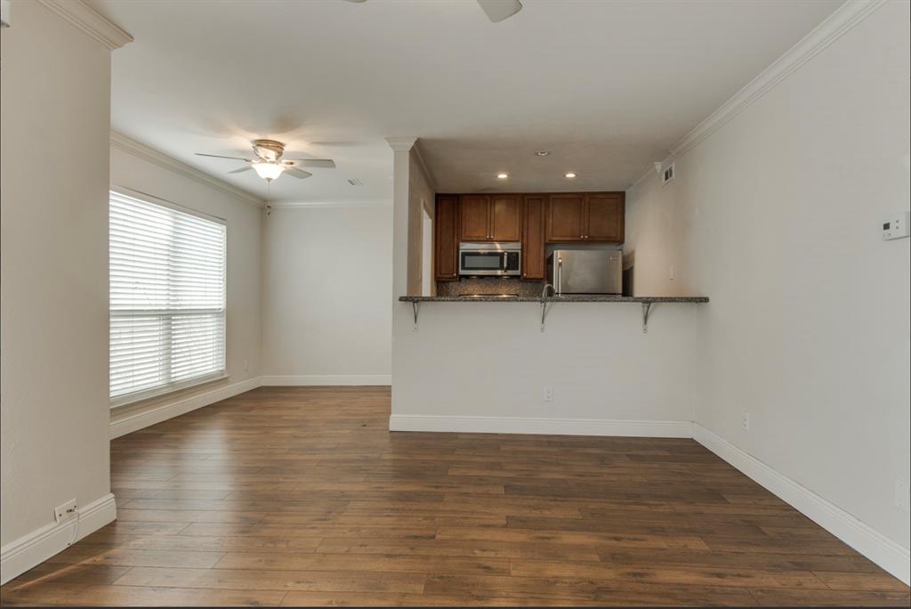 3907 Gilbert Avenue, Unit 3 Dallas, TX 75219 - Photo 1 of 9 an empty room with wooden floor and windows