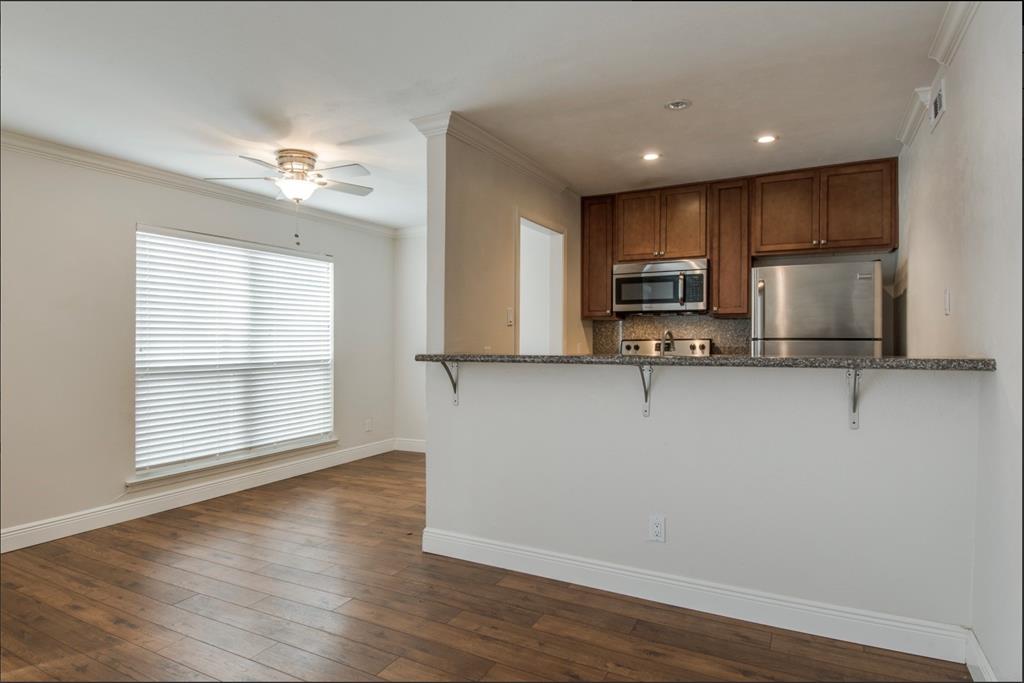 3907 Gilbert Avenue, Unit 3 Dallas, TX 75219 - Photo 4 of 9 a view of a kitchen with a sink cabinets and wooden floor
