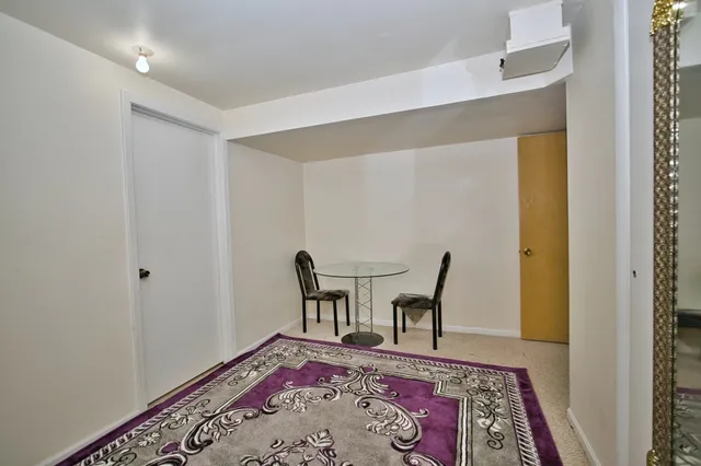 a view of a bedroom with furniture and wooden floor
