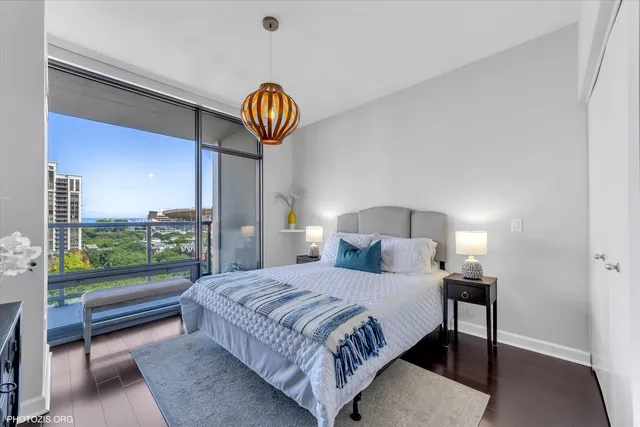 a bedroom with a bed and a chandelier