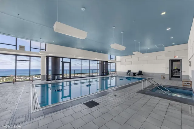 a view of a kitchen with stainless steel appliances wooden floor and a counter top space
