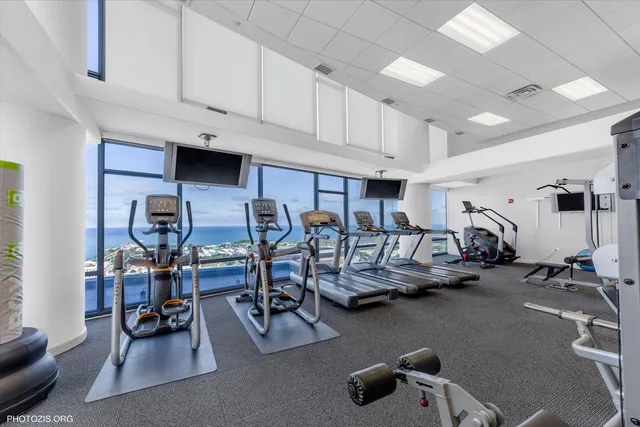 a living room with furniture and large windows
