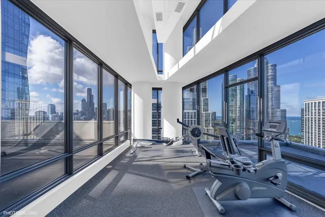 a living room with furniture and a floor to ceiling window