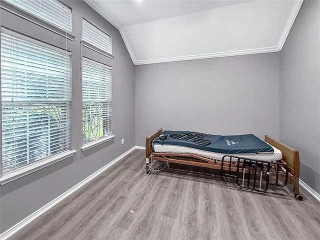 a bedroom with a bed and a large window