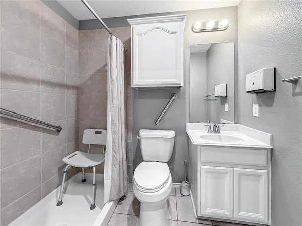 a bathroom with a toilet sink and mirror