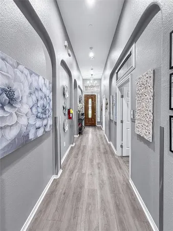 a view of hallway with wooden floor and stairs