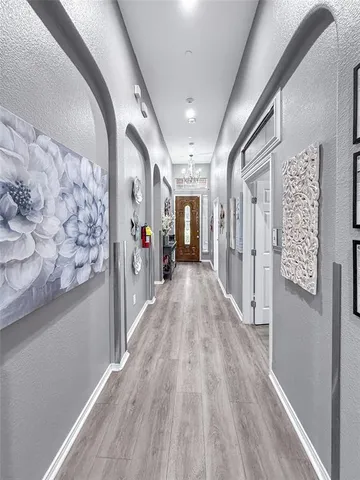 a view of hallway with wooden floor and stairs