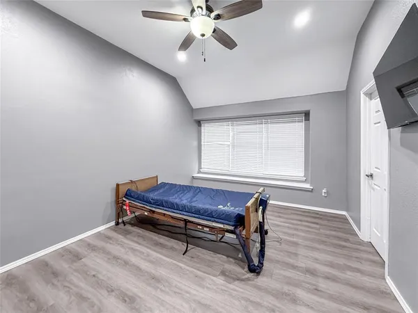 a room with wooden floor and windows