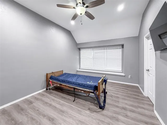 a room with wooden floor and windows