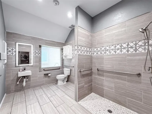 a bathroom with a toilet and a shower