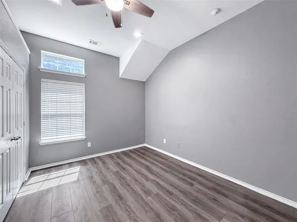 an empty room with a empty space and windows