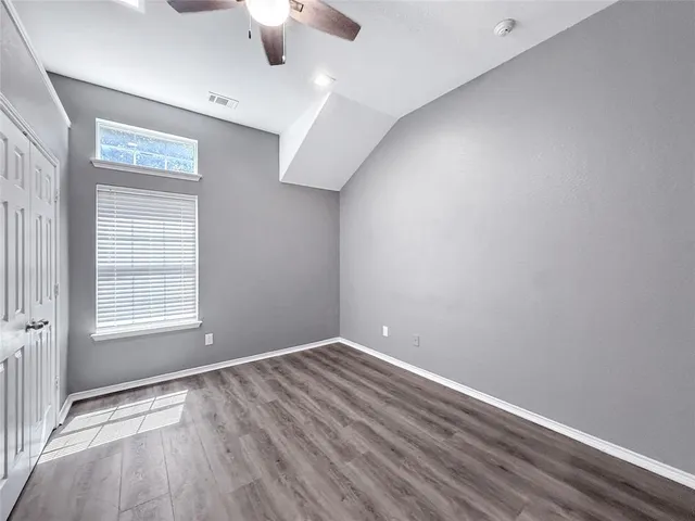 an empty room with a empty space and windows