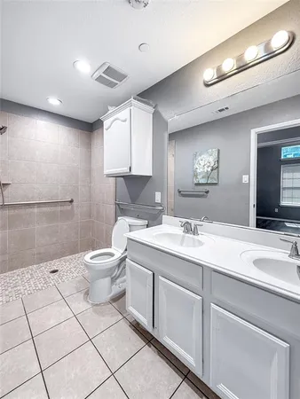 a bathroom with a sink a toilet and a mirror