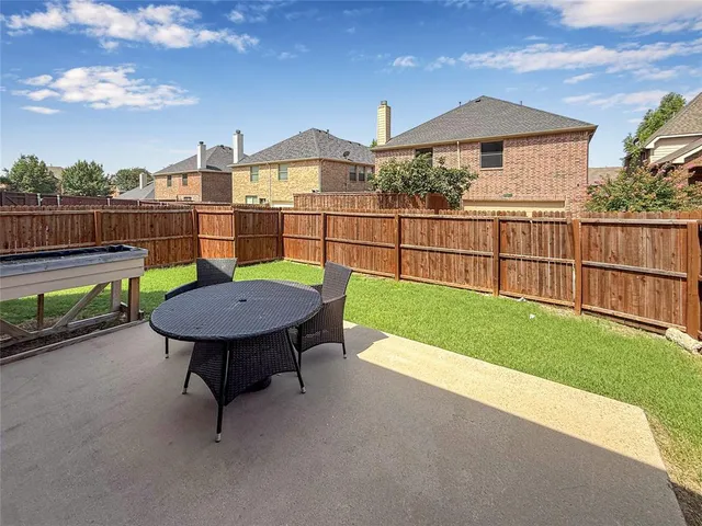 a view of a deck with a table and chair under an umbrella