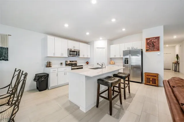 a kitchen with granite countertop a sink stove and microwave