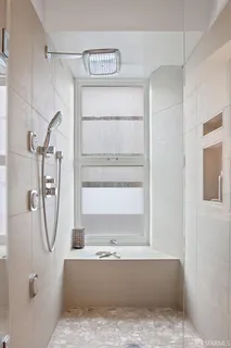 a view of a bathroom with a tub and a window