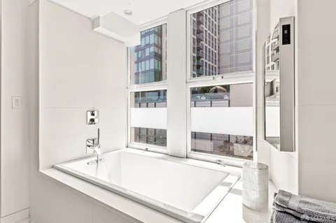 a bathroom with a tub sink and shower