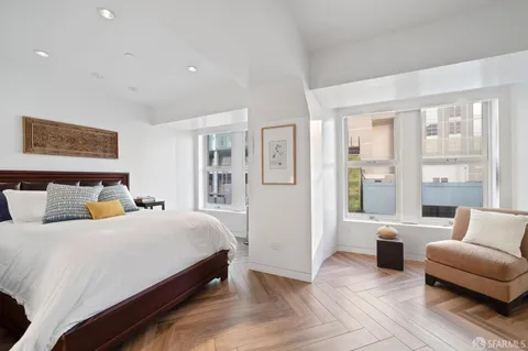 a bedroom with a large bed and a couch