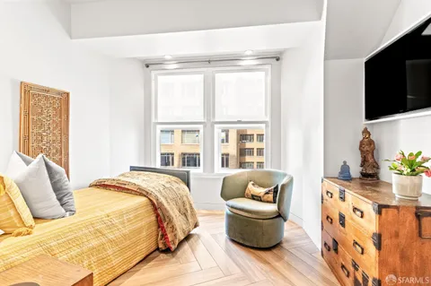 a bedroom with furniture and a flat screen tv