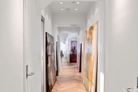a view of a hallway with wooden shelves