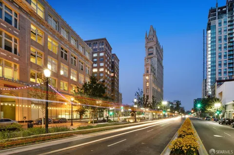 a view of a tall building next to a road