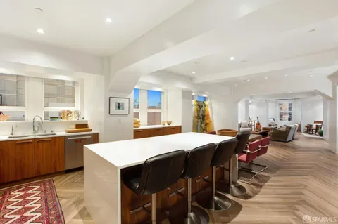 a large kitchen with lots of counter space dining table and chairs