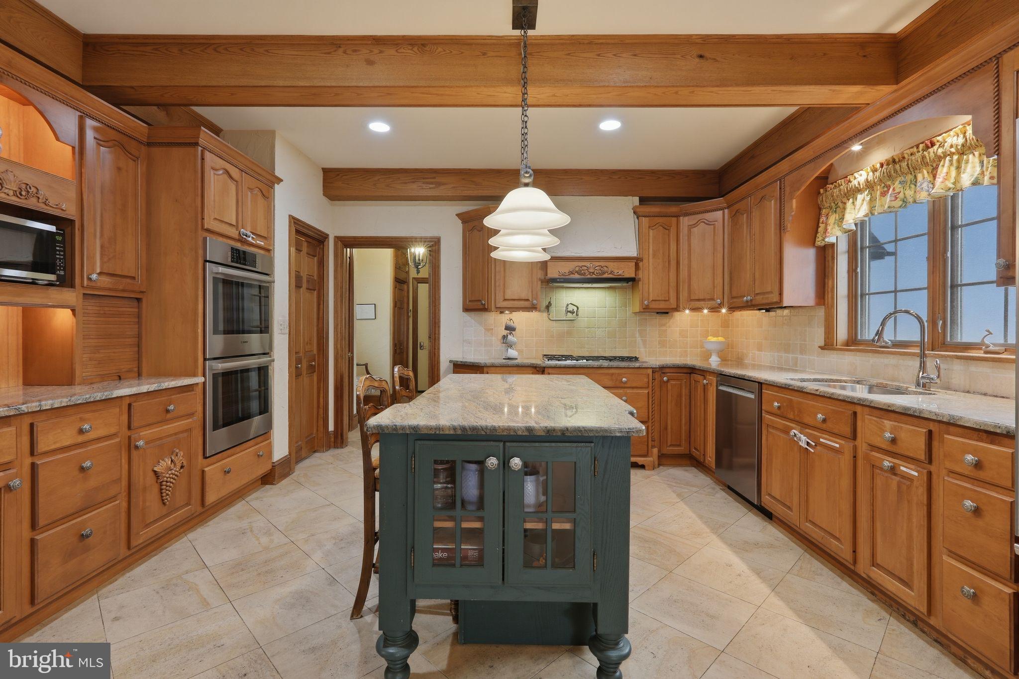 231 Hill Road Elverson, PA 19520 - Photo 19 of 60 a kitchen with stainless steel appliances granite countertop a sink a stove and a wooden cabinets