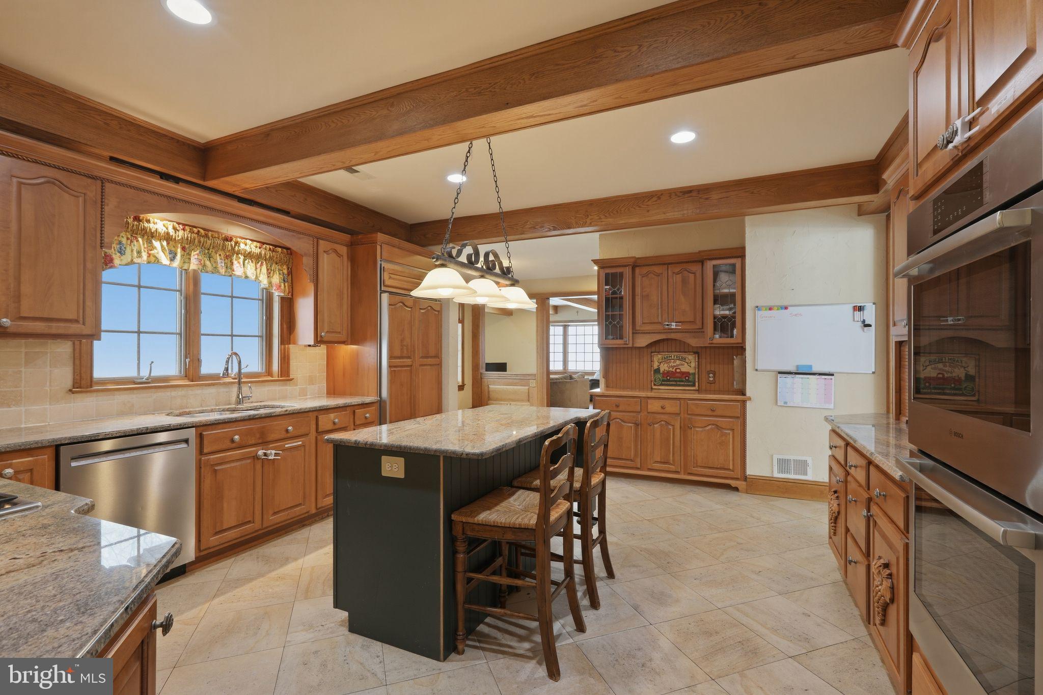231 Hill Road Elverson, PA 19520 - Photo 20 of 60 a kitchen with stainless steel appliances granite countertop a sink and a refrigerator