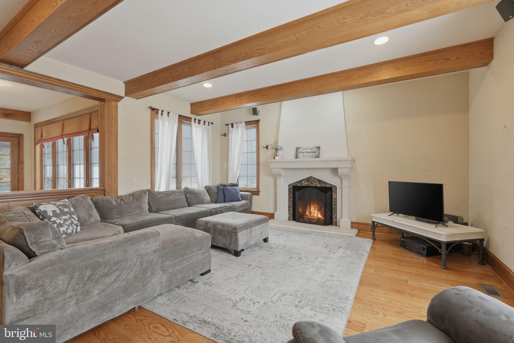 231 Hill Road Elverson, PA 19520 - Photo 23 of 60 a living room with furniture a fireplace and a flat screen tv