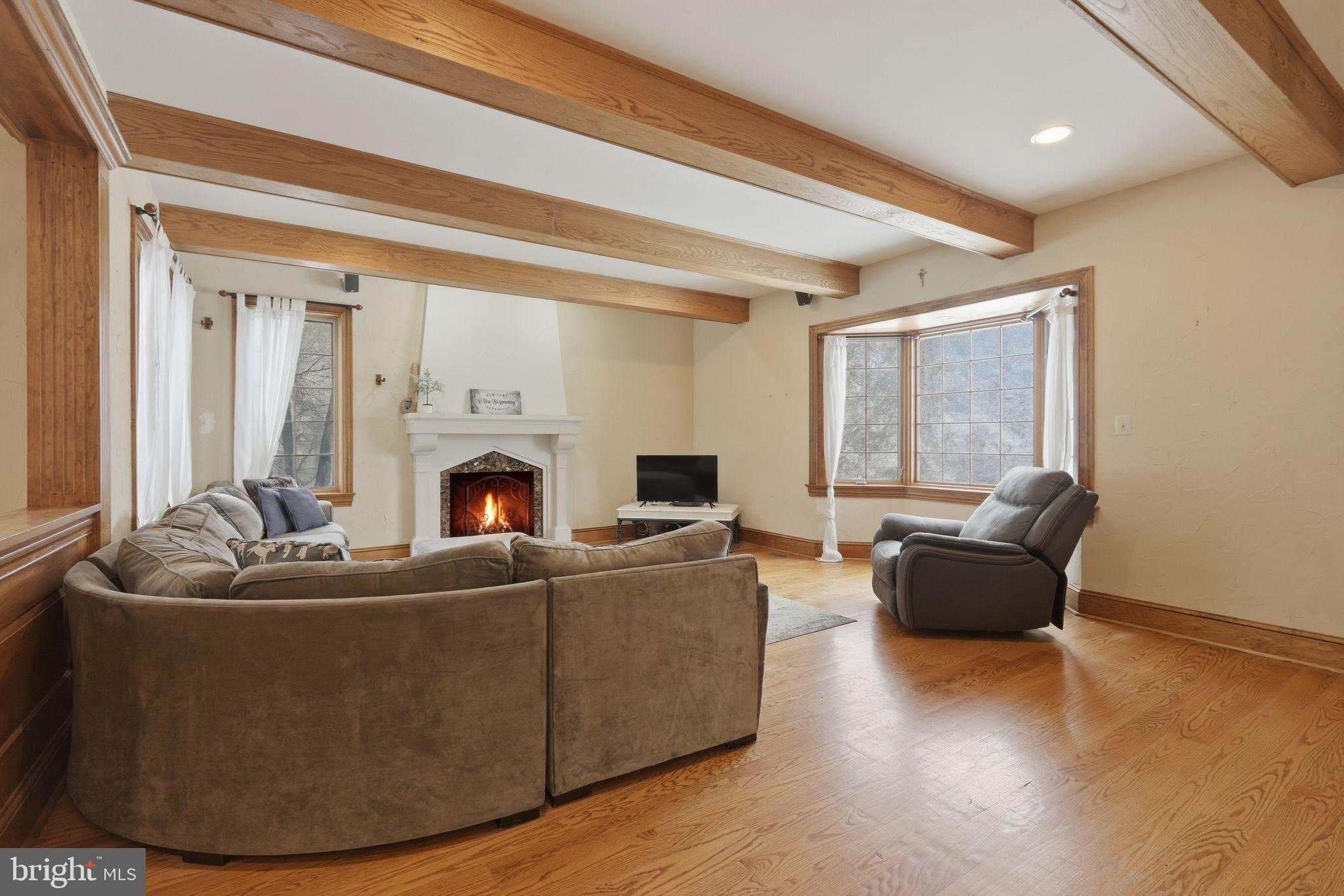 231 Hill Road Elverson, PA 19520 - Photo 24 of 60 a living room with furniture a fireplace and a flat screen tv
