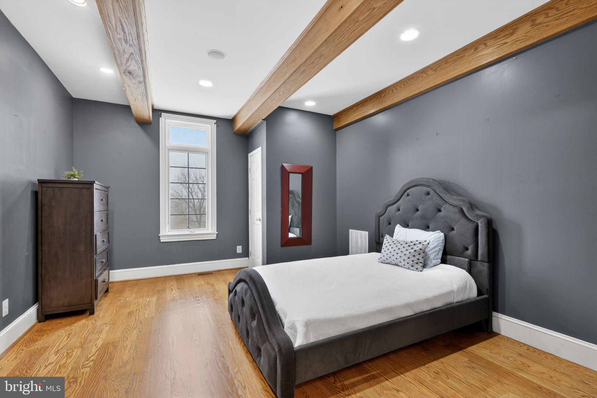 231 Hill Road Elverson, PA 19520 - Photo 28 of 60 a bedroom with a bed and wooden floor