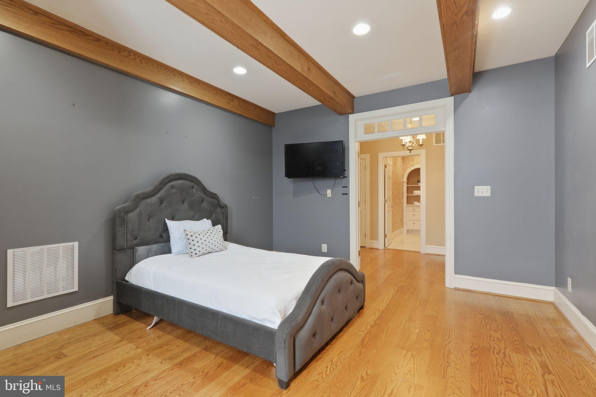231 Hill Road Elverson, PA 19520 - Photo 29 of 60 a bedroom with a bed and a flat screen tv